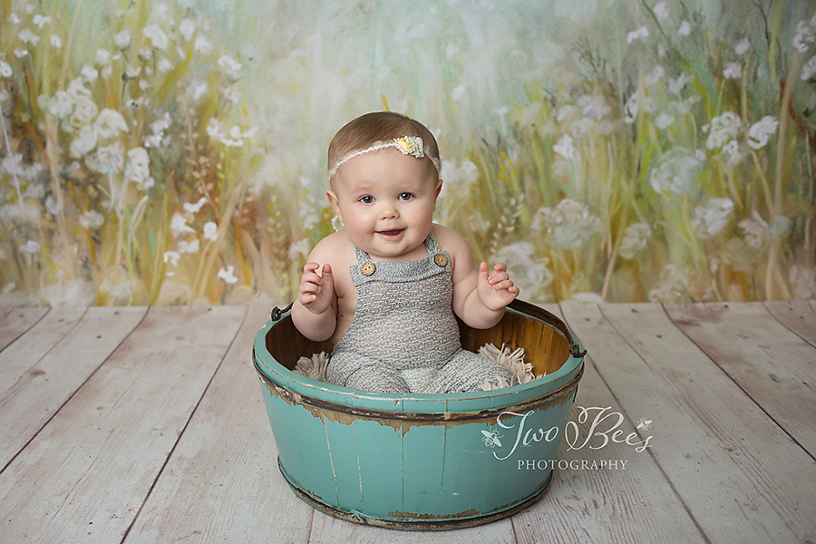 happy baby girl in a bucket