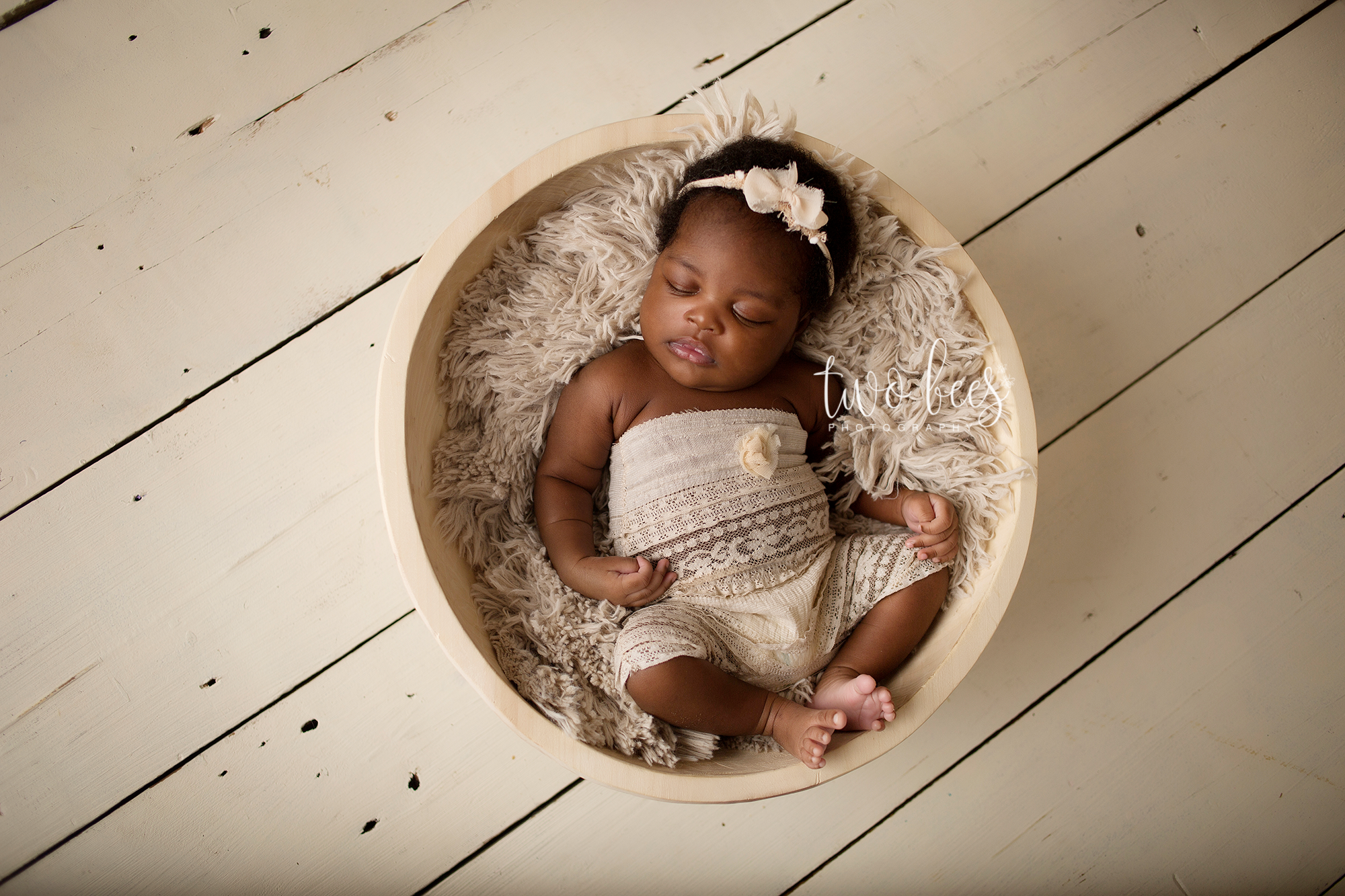 newborn baby girl in a bowl